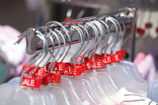 Red Sale Sign on a clothes rail