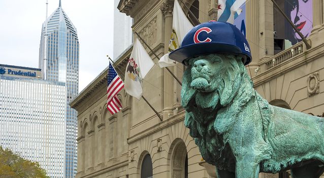 Chicago, IL, USA, October 27, 2016: Lion Statue with Chicago Cubs hat. The statue is one of a pair of bronze lions that flank the main entrance of The Art Institute of Chicago.