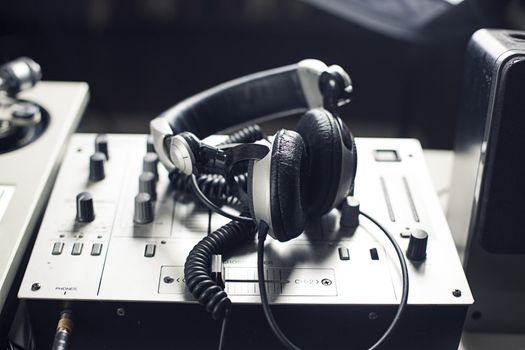 DJ mixer and headphones with a vinyl record, close up.