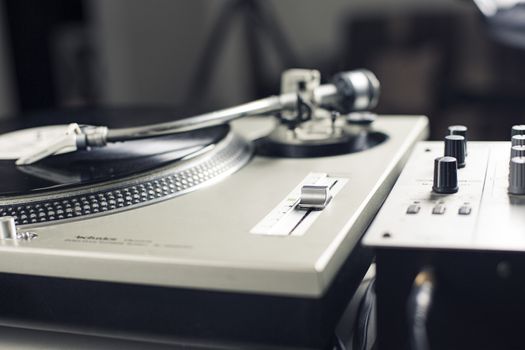 DJ mixer with a vinyl record, close up. 