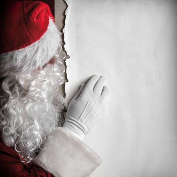 Santa Claus holding big blank paper card with copy space