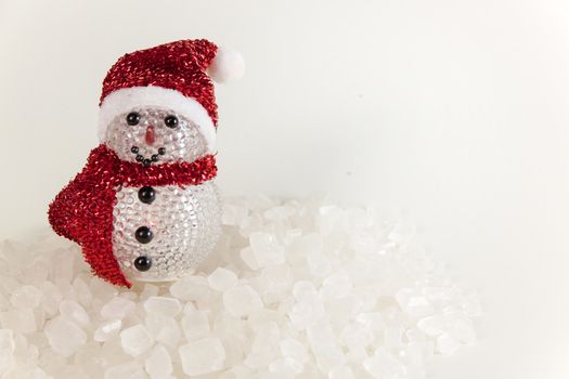 Snow Man on a pile of white crystalline with white background.