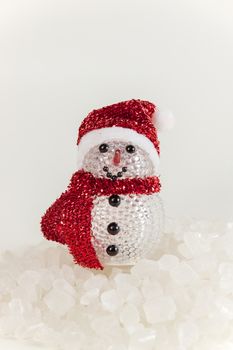 Snow Man on a pile of white crystalline with white background.