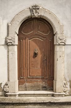 The entrance wooden door in an old Italian house