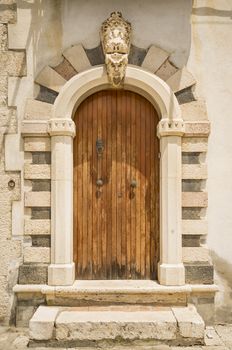 The entrance wooden door in an old Italian house