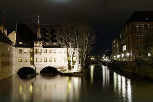 NUREMBERG, GERMANY - DECEMBER 02, 2015: Hospice of the Holy Spirit at night, one of the main landmarks of Nuremberg, Germany