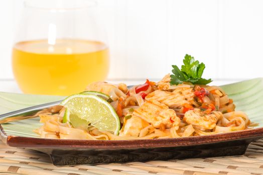 Closeup view of a plate of chicken pad thai.