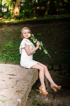 beautiful girl with a white rose in the Park