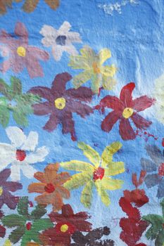 Blue Bricks and painted Flowers  in a  brick Wall
