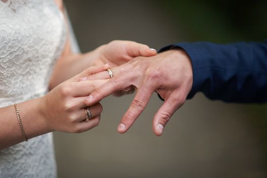 bride dress ring for groom on wedding ceremony.