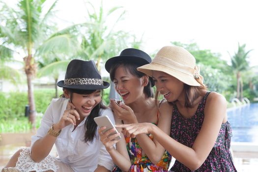 portrait group of asian woman laughing with happiness emotion and looking to smart phone use for people modern lifestyle in digital technology