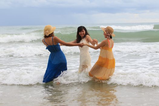 portrait group of young asian woman playing with happiness emotion on vacation sea beach use for people lifestyle activities leisure on traveling sea destination