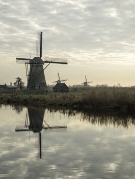 UNESCO World Heritage windmills in Kinderdijk in Holland europe, windmills at the water with reflection and twilight