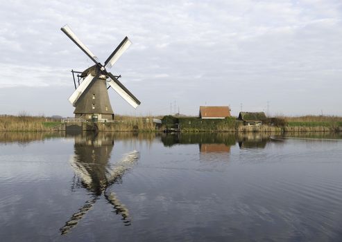 UNESCO World Heritage windmills in Kinderdijk in Holland europe, windmills at the water with reflection and twilight