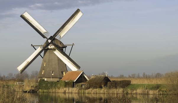 UNESCO World Heritage windmills in Kinderdijk in Holland europe, windmills at the water with reflection and twilight