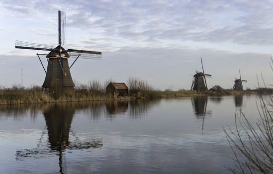 UNESCO World Heritage windmills in Kinderdijk in Holland europe, windmills at the water with reflection and twilight