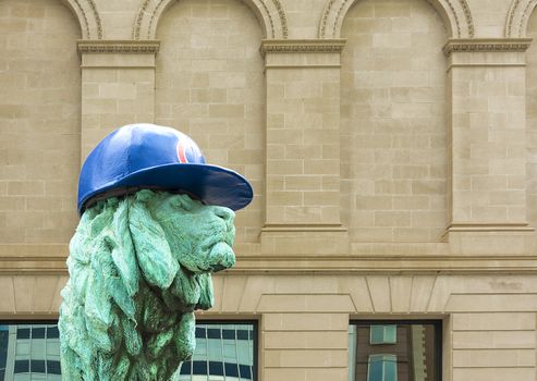 Chicago, IL, USA, october 27, 2016: Chicago Art Institute entrance lion sculpture with Chicago Cubs hat