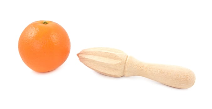 Whole orange and wooden citrus reamer, isolated on a white background