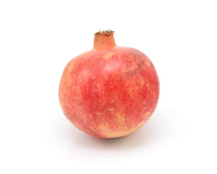 Whole pomegranate, with tough red and yellow skin, isolated on a white background