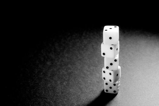 Five dice disposed in vertical position on a black background