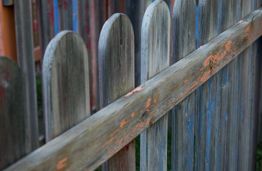 An old colored wooden fence in a playground