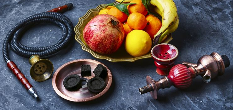 banner with smoking hookah and dish with tangerines,pomegranate and banana