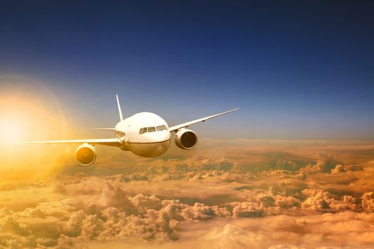 air plane flying over cloud scape and sun light behind