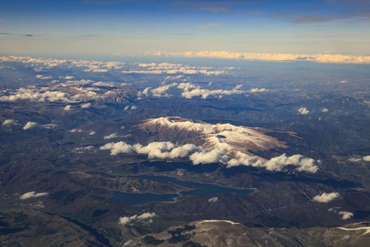 landscape from plane window of high mountain in italy after plane taking from Fiumicino Leonardo da Vinci International Airport 