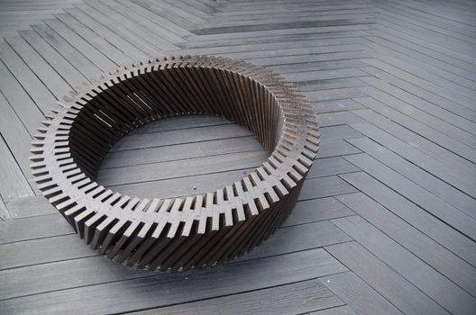 Round wooden bench in the street without people