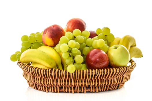 Wicker basket with fruits: banana, grape, peach, apple