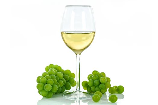 Ripe grapes and wine glass isolated on white