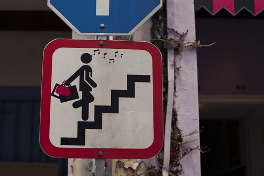 Road sign with glamor woman on stair