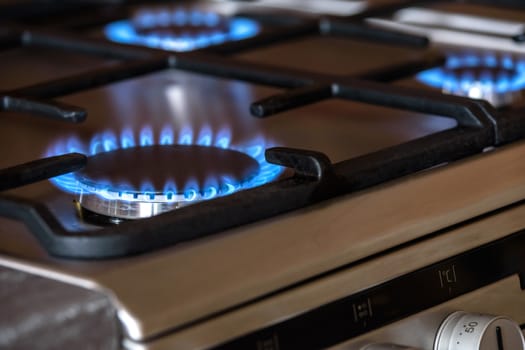 Burning blue burners on a metal cooker