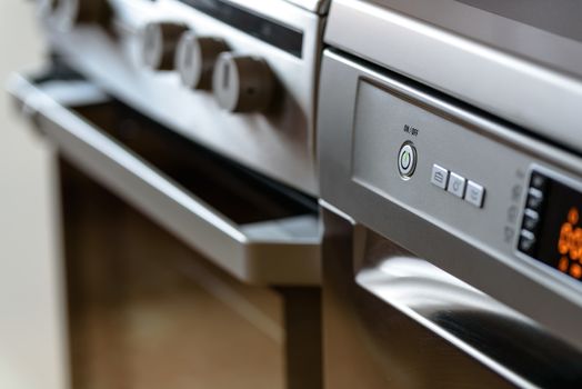 Metallic stove and dishwasher in the kitchen