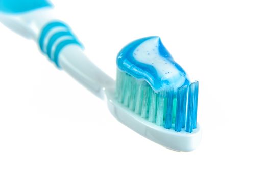 A blue toothpaste and toothbrush on white background