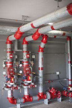 Heating system's cooper pipes with ball valves on a white wall