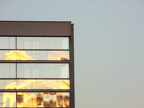 Modern Glass and Concrete Building on the left Side Corner of deep blue Sunset Sky Background