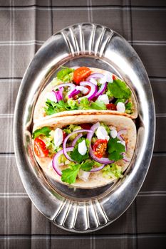 Chicken Tacos with vegetables on a pan.