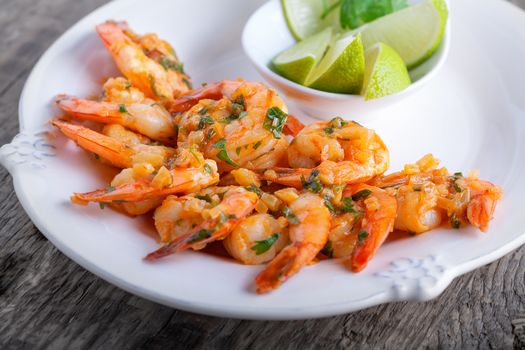Fried Prawns with lime on a white plate.