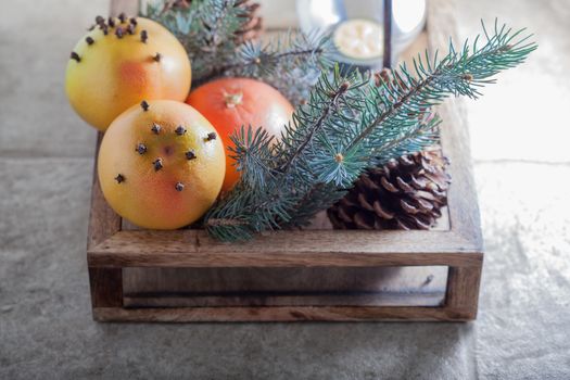 Christmas symbols including grapefruits in wooden box .