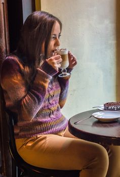 beautiful girl drinking coffee in a cafe