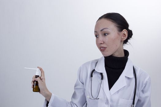 Young female doctor on a white background