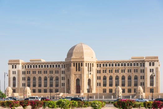 The Supreme Court of Oman in Muscat, The Sultanate of Oman. Cars in the foreground are blurred due to motion.
