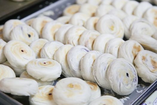 baked delicious bun with taro and cream inside on tray