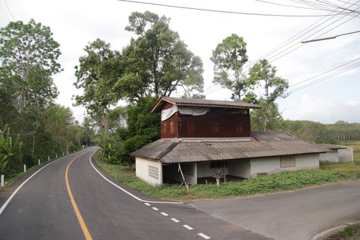 Two floor house in a corner of a road