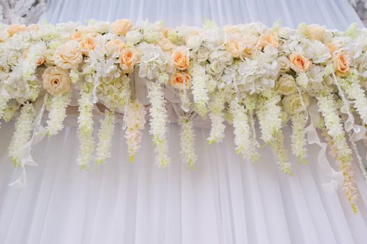 beautiful arch with white roses for wedding ceremony.