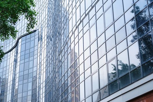 multi-storey office building with glass on sky background