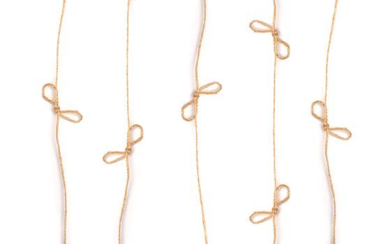 lines flaxen ropes with bows and knots on a white background.
