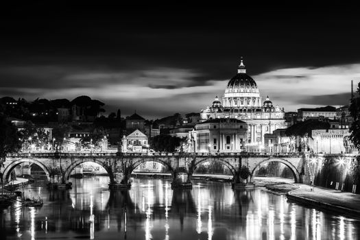Night view of old roman Bridge of Hadrian and St. Peter's cathedral in Vatican City Rome Italy.