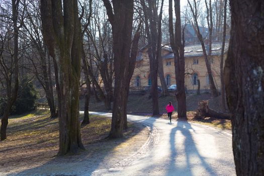 Lady running in the forest.  Running woman. Female runner jogging during outdoor workout in a Nature. Fitness model outdoors. Weight Loss. Healthy lifestyle. 